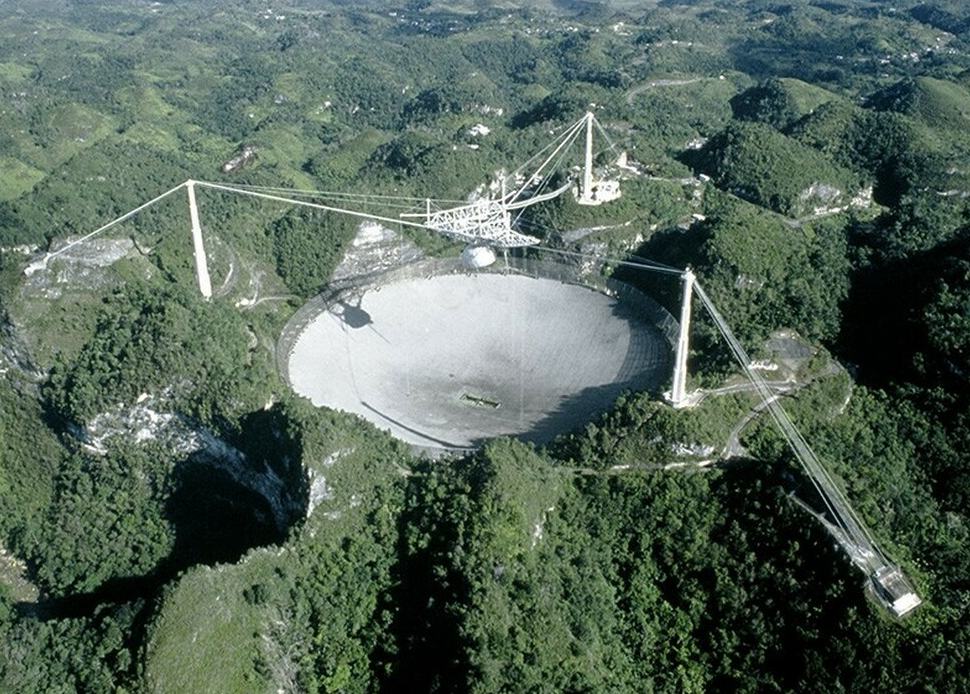 Fig. 2 - Un’immagine del telescopio di Arecibo, fino a poco tempo fa il più grande del mondo. Nel 2011 ha scoperto un lampo radio riuscendo a localizzarlo con precisione. Questo ha permesso di scoprire la galassia ospite, distante 2 miliardi di anni luce. È la prova che i lampi radio sono extragalattici - Crediti: Wikipedia.