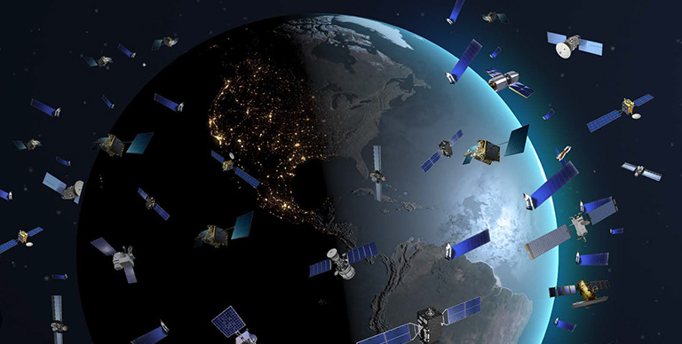 Fig. 3 - Immagine pittorica di satelliti attorno alla Terra che servono per la nostra navigazione sul nostro pianeta - Crediti: Il Post.